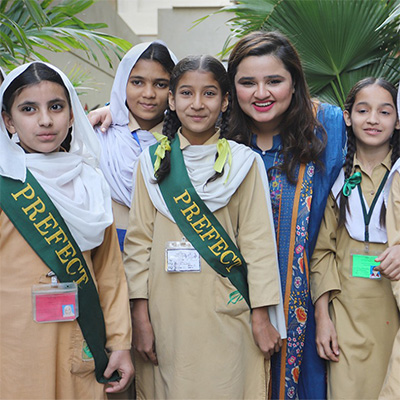 Photo of Faiza Saleem with TCF students